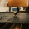 Industrial laser engraving machine cutting metal with sparks - Endless Etchings laser engraving Pompano Beach FL